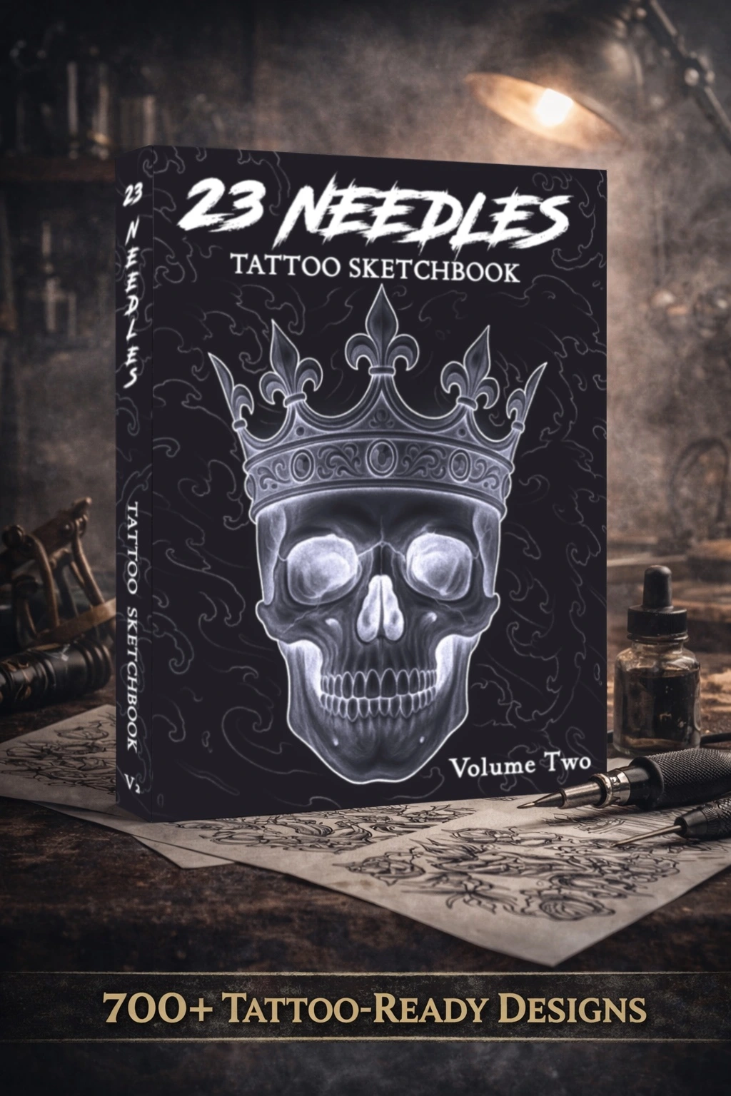23 Needles Tattoo Sketchbook Volume Two promotional photo, featuring a crowned skull cover and 700+ tattoo-ready designs